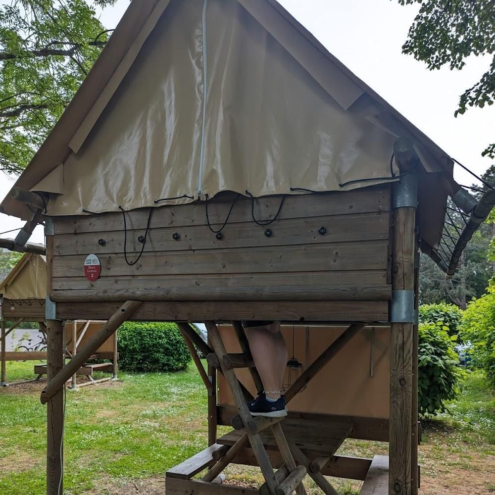 A wooden platform with a tent on top.